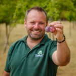Wayne holding a plum